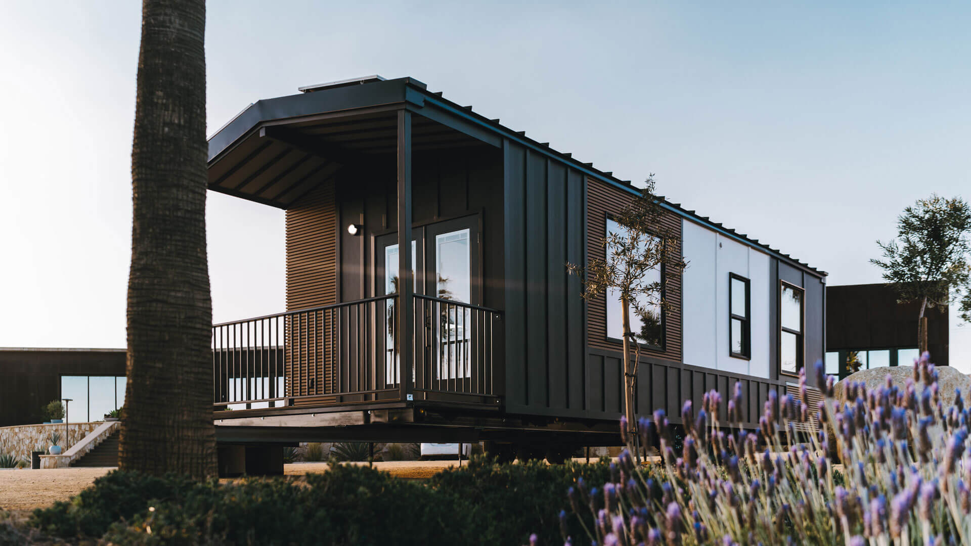 tiny home with a porch at sunset