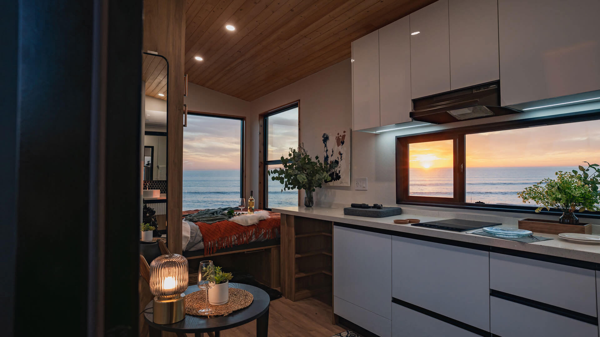 queen sized bed in a tiny home with an ocean view