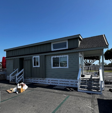 Green tiny house with porch