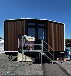 Brown modern tiny home with stairs